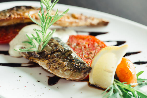 istock Grilled mackerel with onion on white plate 1143561300