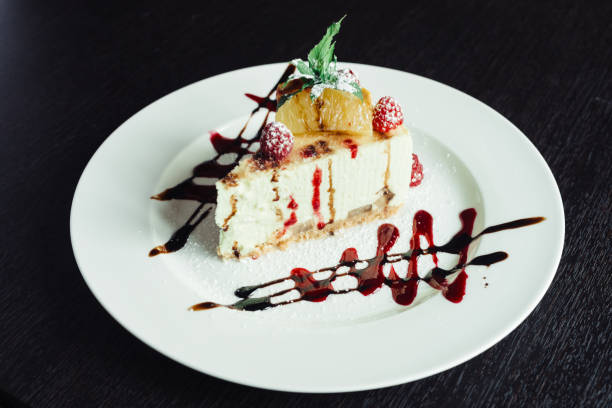 istock Philadelphia cake with raspberries and orange slice on white dish 1143561309