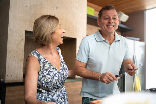 istock Couple singing and dancing during barbecue 1143564025