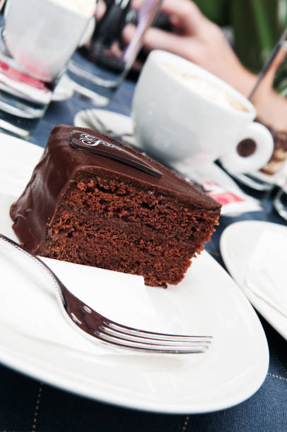 istock Chocolate cake on white plate and a cup of espresso coffee 1143565158