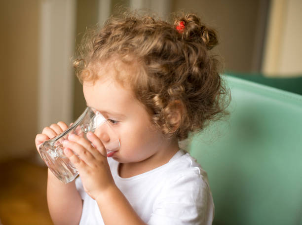 istock Little girl drinking water 1143566748