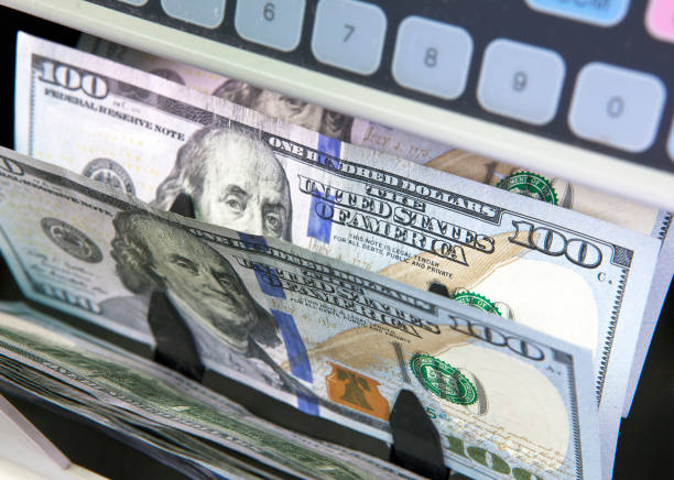 istock electronic money counter machine is counting is counting the American hundred-dollar (US dollars) banknotes 1143571043