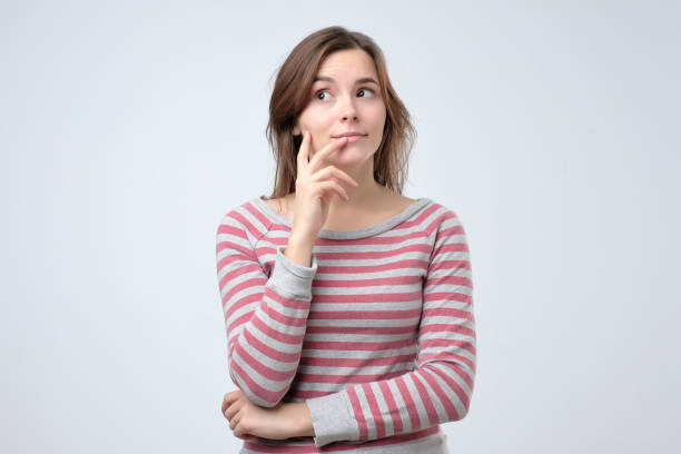 istock Thoughtful young woman looking away planning her next day. 1143575374