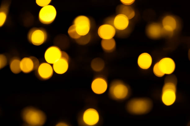istock Abstract gold bokeh on black background. Defocused yellow lights, abstract texture 1143578109