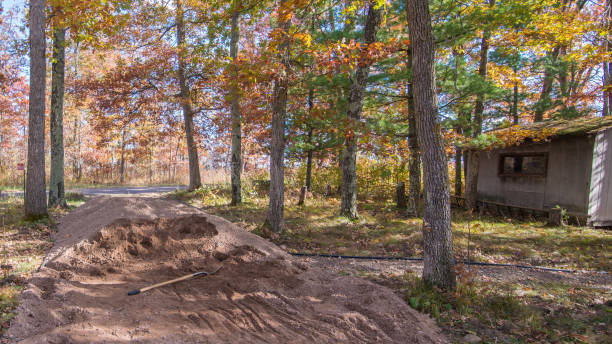 istock Crushed rock pile with shovel with rustic shed in background - rural road and walking path project in a beautiful colorful fall foliage forest 1143580822