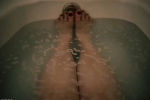 polished toes Sticking Up Out of Bathwater