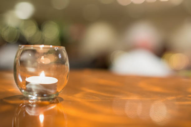 Candle in glass on copper table - catered event like wedding, reception, anniversary, etc..