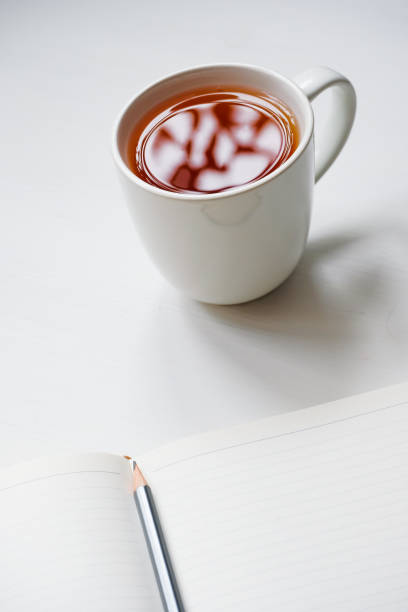 istock Cup of tea with notebook and pencil on wooden table 1143586930