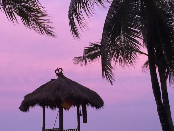 Beach hut against pink sky stock photo