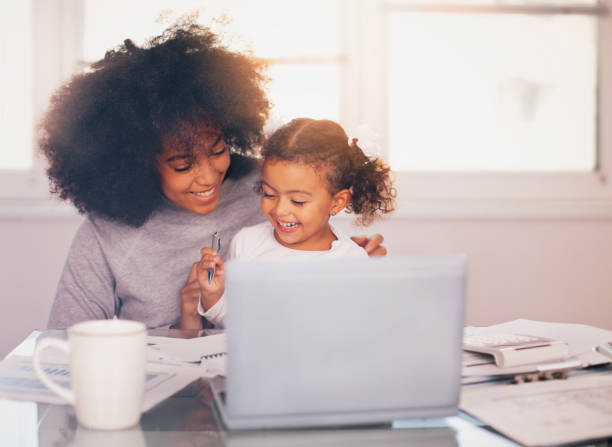 istock Young mother working and spending time with her daughter 1143596452
