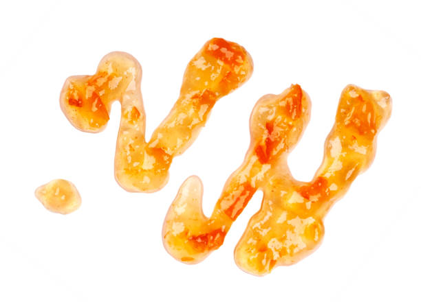 istock Orange thick jam drizzle, isolated on white background. Mandarin marmalade, sauce, topping drops. Top view. 1143600799