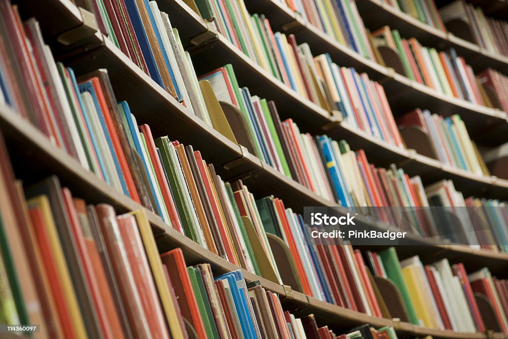 Library bookshelf full of books Bookshelf in library with many books. Shallow dof. Book Stock Photo