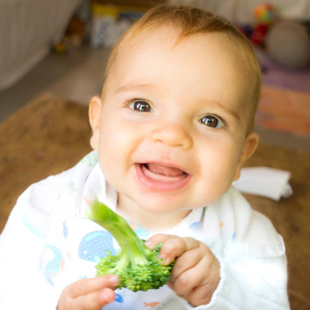 istock Baby with fruits 1143605798
