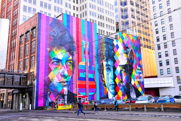 Minneapolis, Minnesota USA. 01/05/2019: Streets of Downtown Minneapolis in winter months. A street with public train transport with cables running along street and bright mural visible to the public.
