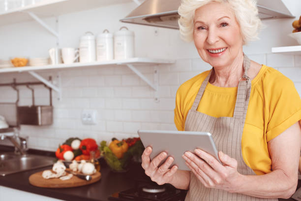 istock Handsome pensioner watching a video recipe on the Internet on a tablet 1143611538
