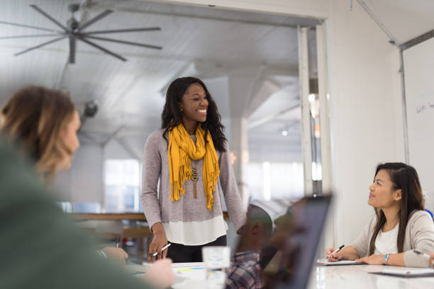 istock Female CEO leads a team meeting 1143614326