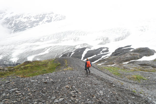 istock Sole male hikes up a glacier 1143614443