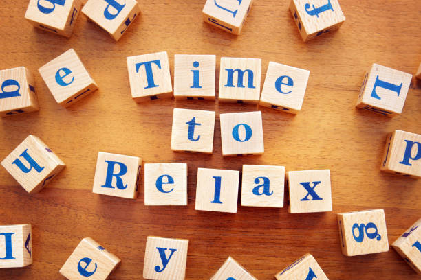 istock Time to relax. Conceptual image with the text made from wooden cubes on a desk 1143615775