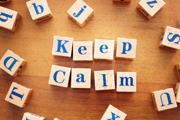 istock Keep calm. Conceptual image with the text made from wooden cubes on a desk 1143615904