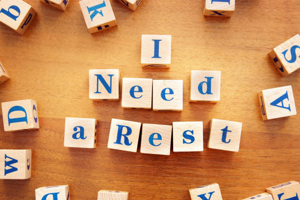 istock I need a rest. Conceptual image with the text made from wooden cubes on a desk 1143616427