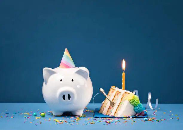 Photo of Slice of Birthday Cake with Piggy Bank