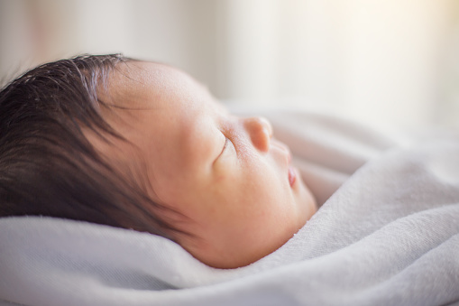 Closeup portrait of asian newborn baby asleep, vintage color