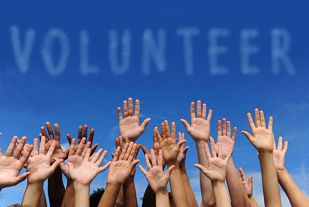 istock Multiethnic hands raised under word 