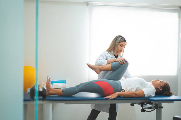 istock GPR - Global Postural Re-education, doctor doing stretching on her patient's legs 1143626909