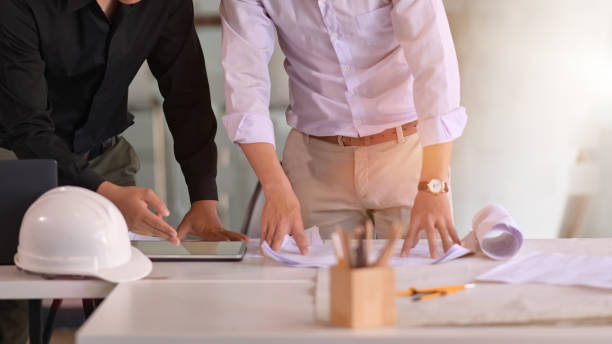 istock Business people and engineer in a meeting using tablet 1143627647
