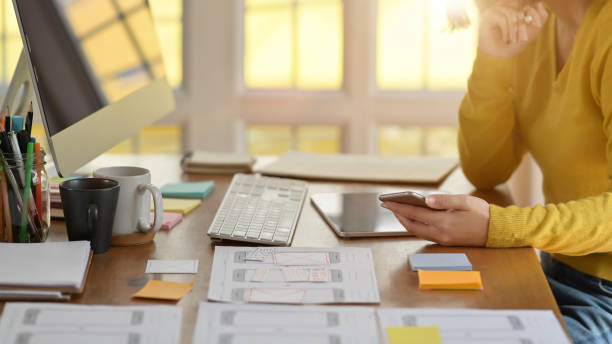 istock UX designer designing web on tablet for smartphone layout in office 1143627707