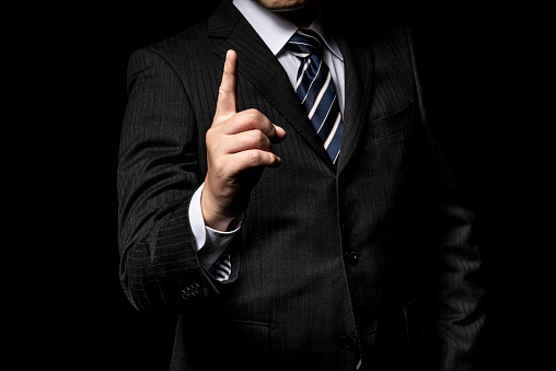 Businessman pointing a finger