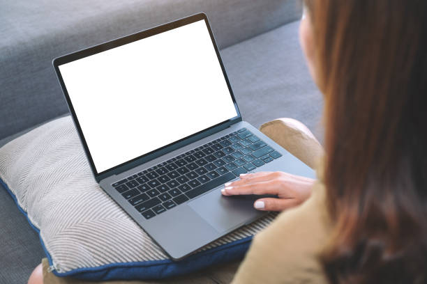 istock a woman using and touching on laptop touchpad with blank white screen while sitting in living room 1143630520