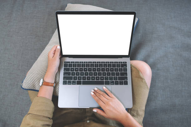 istock a woman using and touching on laptop touchpad with blank white screen while sitting in living room 1143630620
