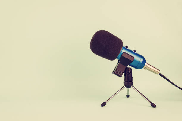 istock Blue microphone with wire on pastel tone in vintage style. 1143630760