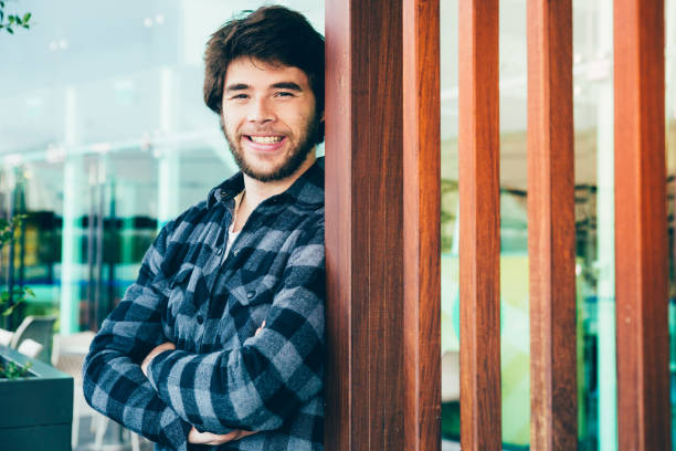 istock Smiling attractive man standing outdoors with his arms crossed 1143630982