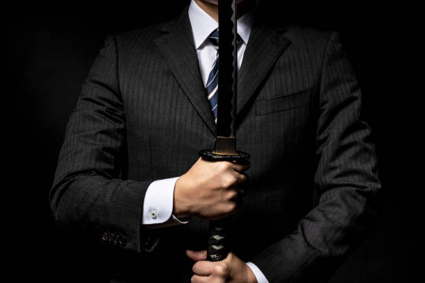 istock Businessman holding a Japanese sword 1143630984