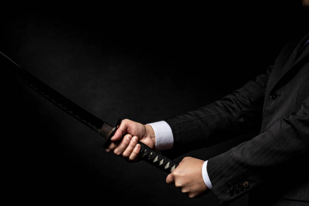 istock Businessman holding a Japanese sword 1143631008