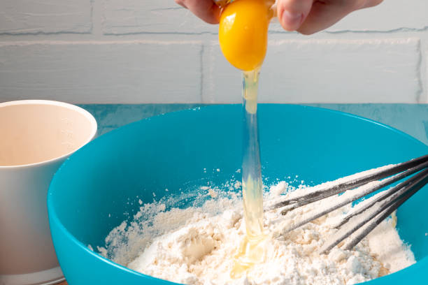istock Breaking an egg into flour while preparing the dough - photo, image 1143631898