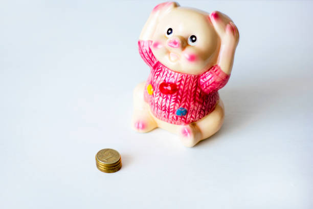 istock Ceramic money box on the table on a light background. Space for text 1143633259