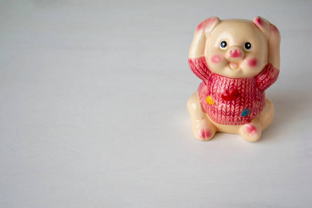istock Ceramic money box on the table on a light background. Space for text 1143633335