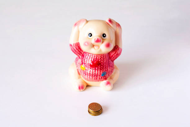 istock Ceramic money box on the table on a light background. Space for text 1143633351