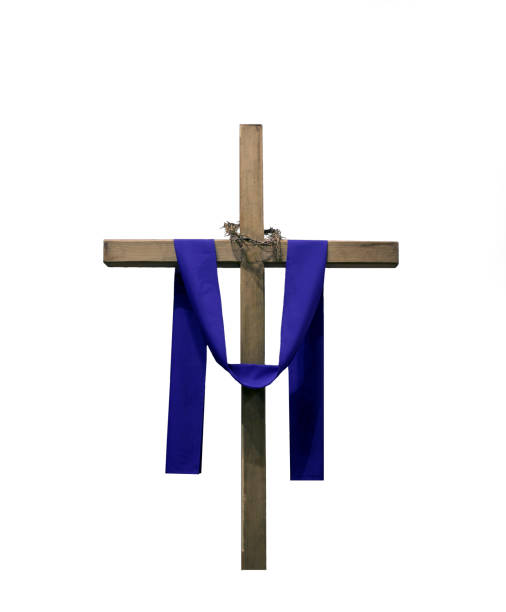 Wooden cross draped with purple fabric and thorns stock photo