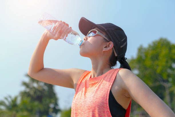 istock Athlete woman drinking water after work out exercising. 1143637425