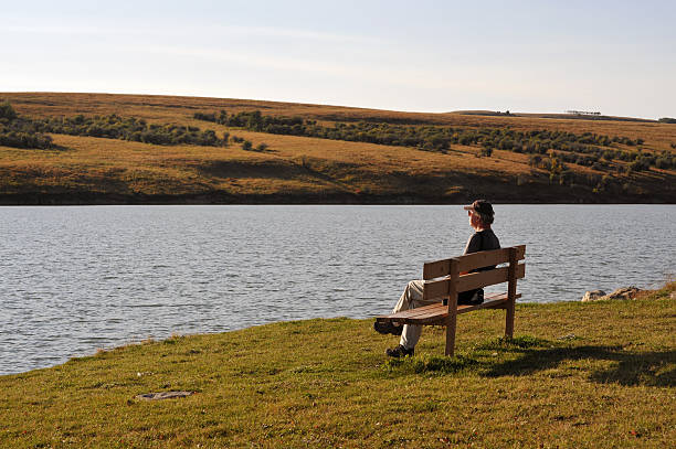 istock Man relaxing  on a bench near the lake. 114363855