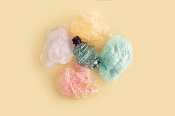 istock Plastic bags and bottles on yellow background. No plastic garbage concept. 1143638942
