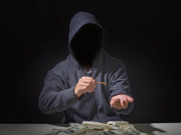 istock Cyber attack with unrecognizable hooded hacker.Hacker steal money in the office. 1143639017