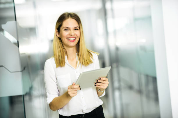 istock Young female holding digital tablet in the office 1143645793