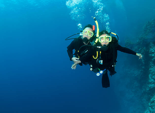 istock happy couple scuba dive together 114364764