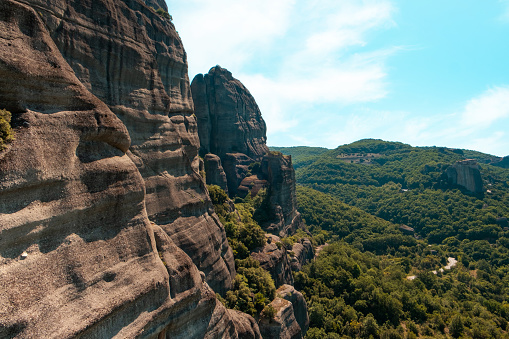 View of a valley and a monastery on a cliff from Meteora mountains