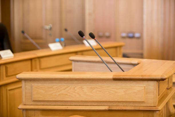 istock before a conference, the microphones in front of empty chairs. 1143653962